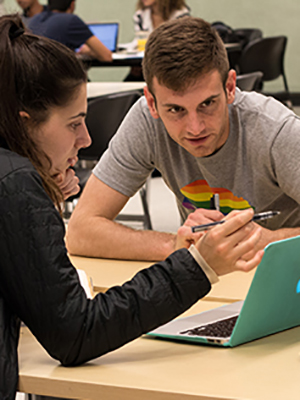 Library undergraduate fellow Ross Mattheis, right, helps student Dafna Bearson at the Data and Reference Help Desk in the Moffitt Library on April 10, 2018. (Photo by J. Pierre Carrillo for the UC Berkeley Library)